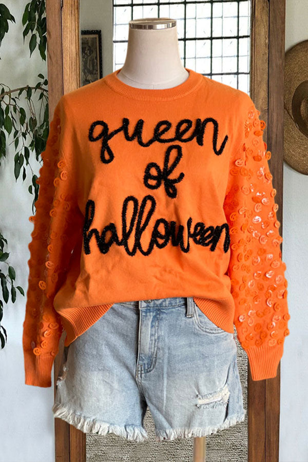 Pull à paillettes brodées avec lettres